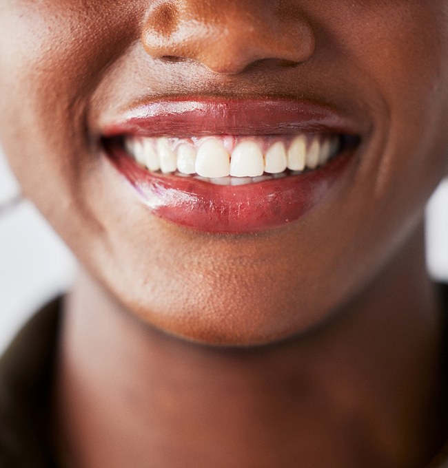 Nose-to-neck closeup of woman smiling