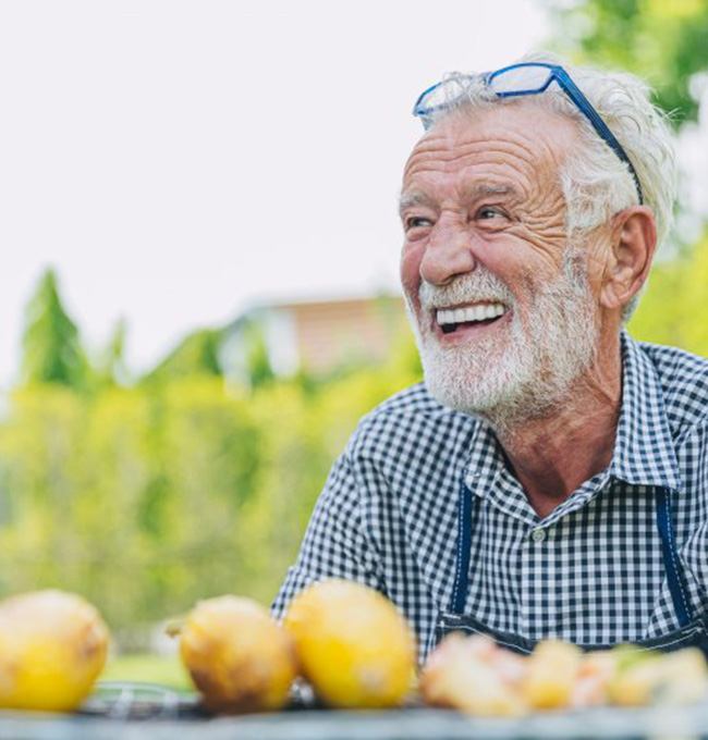 Man smiles outdoors