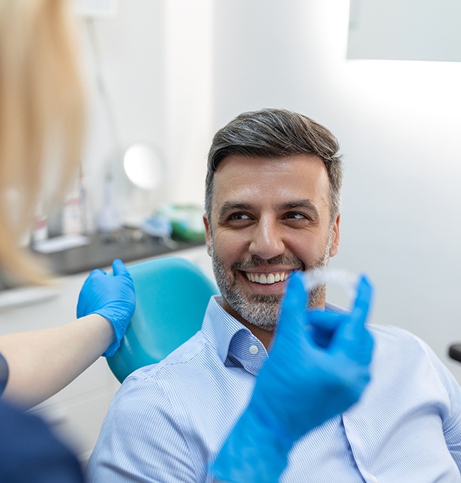 Man talking to dentist about Invisalign 