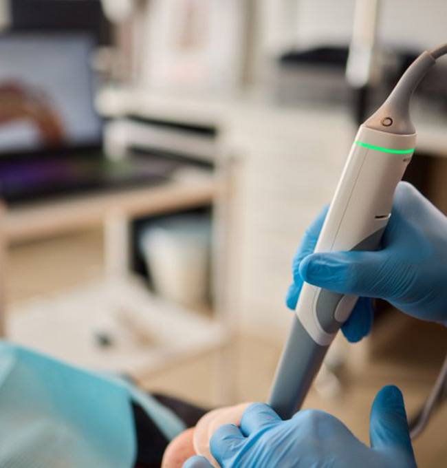 a dentist using an iTero scanner